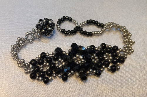 Handcrafted Black & Silver Beaded Necklace on a plain background – handmade Black & Silver beaded jewellery by BeadMeRise