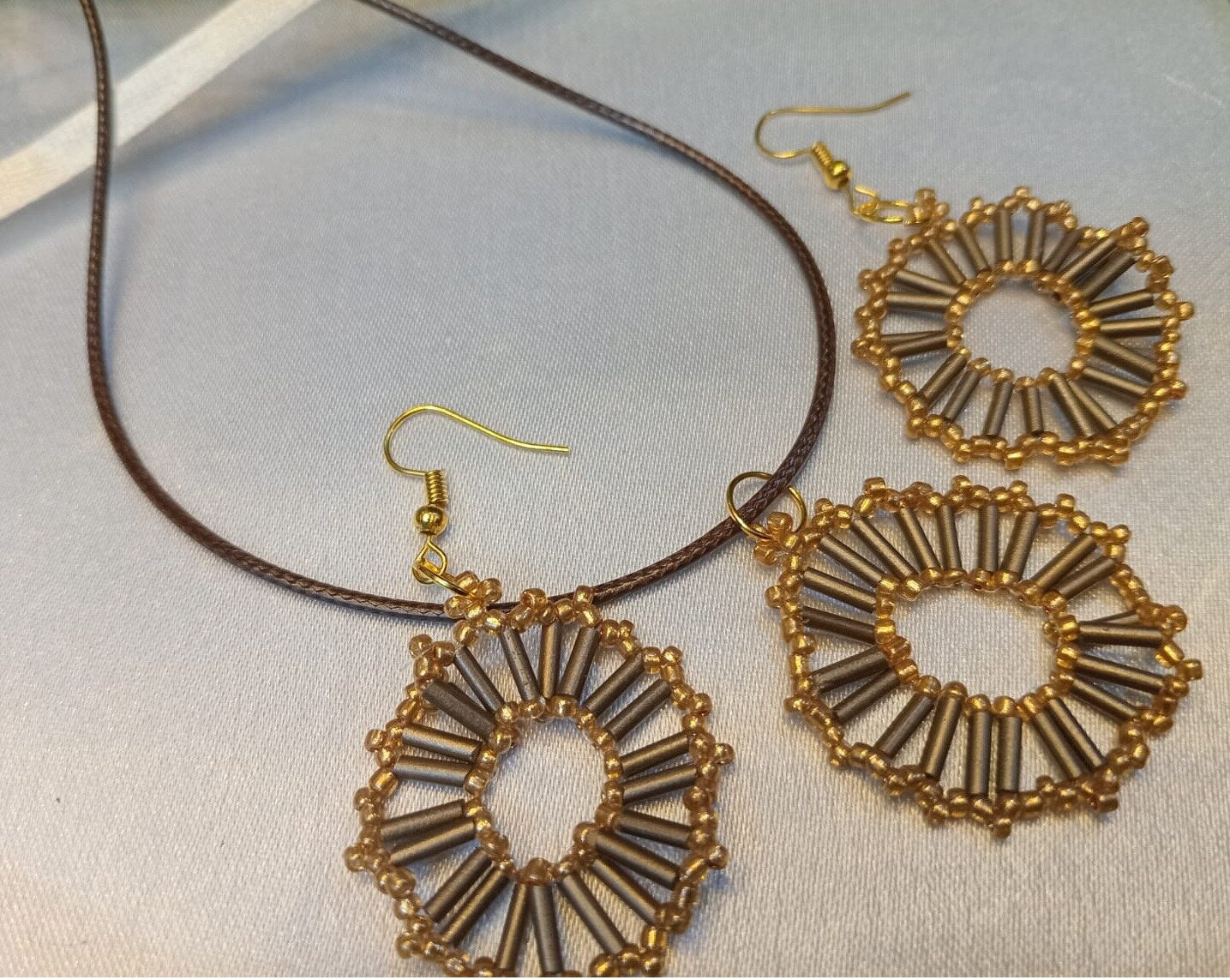 Handcrafted Gold Circle Beaded Drop Earrings on a plain background – handmade Gold beaded jewellery by BeadMeRise