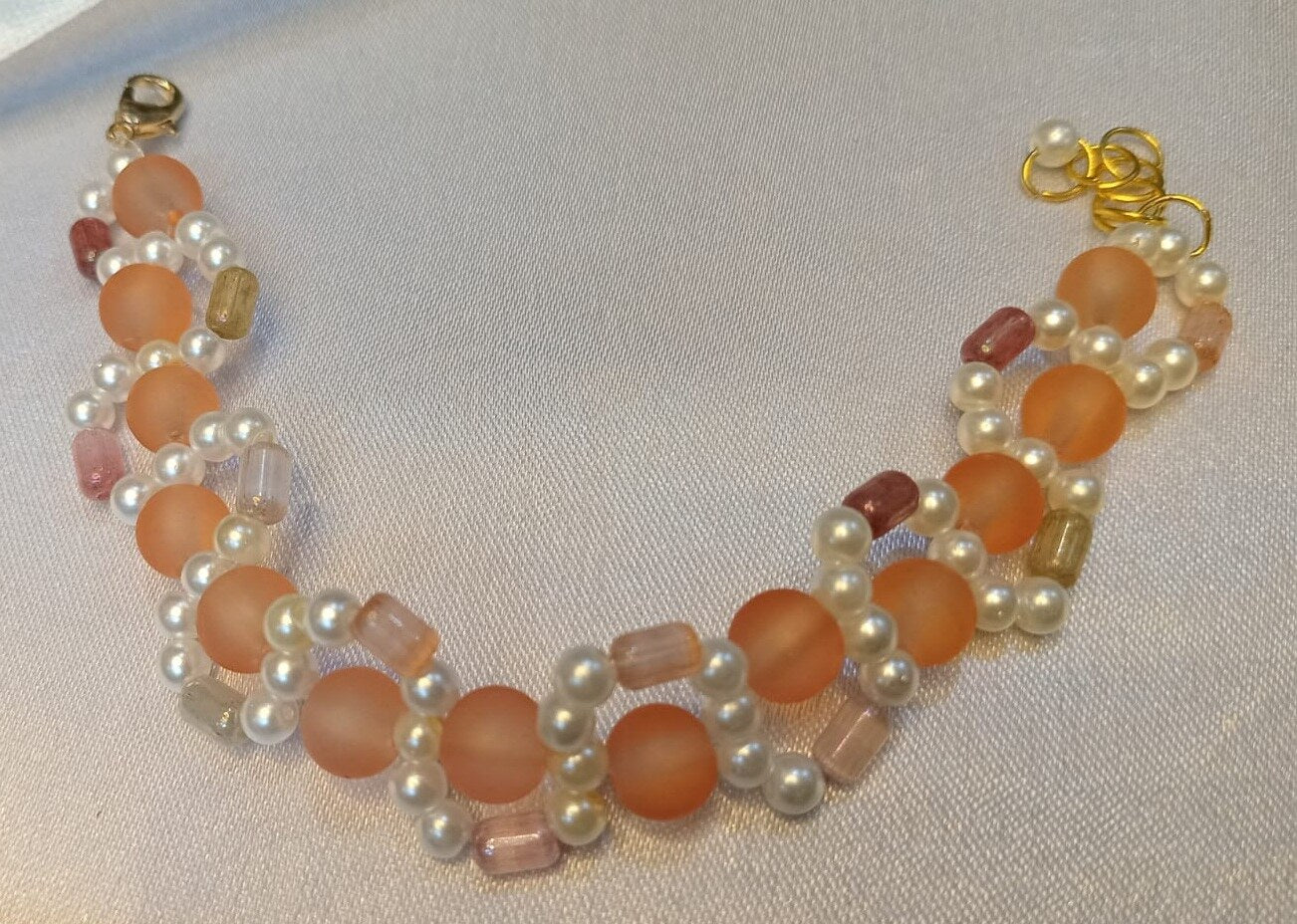 Handcrafted Peach & Pearl Beaded Bracelet on a plain background – handmade Peach & Pearl beaded jewellery by BeadMeRise